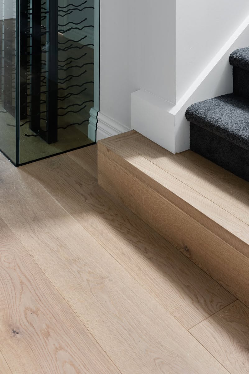 Light oak boards meeting a stair landing